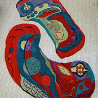 two interlocking textured kidney shaped rugs in red and teal organic shapes